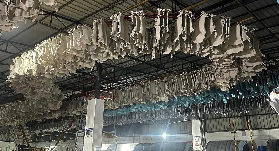 Tannery floor with leather hides stacked in production.